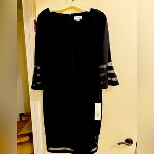Calvin Klein new w/tags black long sleeved dress. Unique design. Evening or day